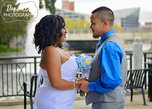 Spring wedding bride and groom exchange vows in front of fountain at the canal
